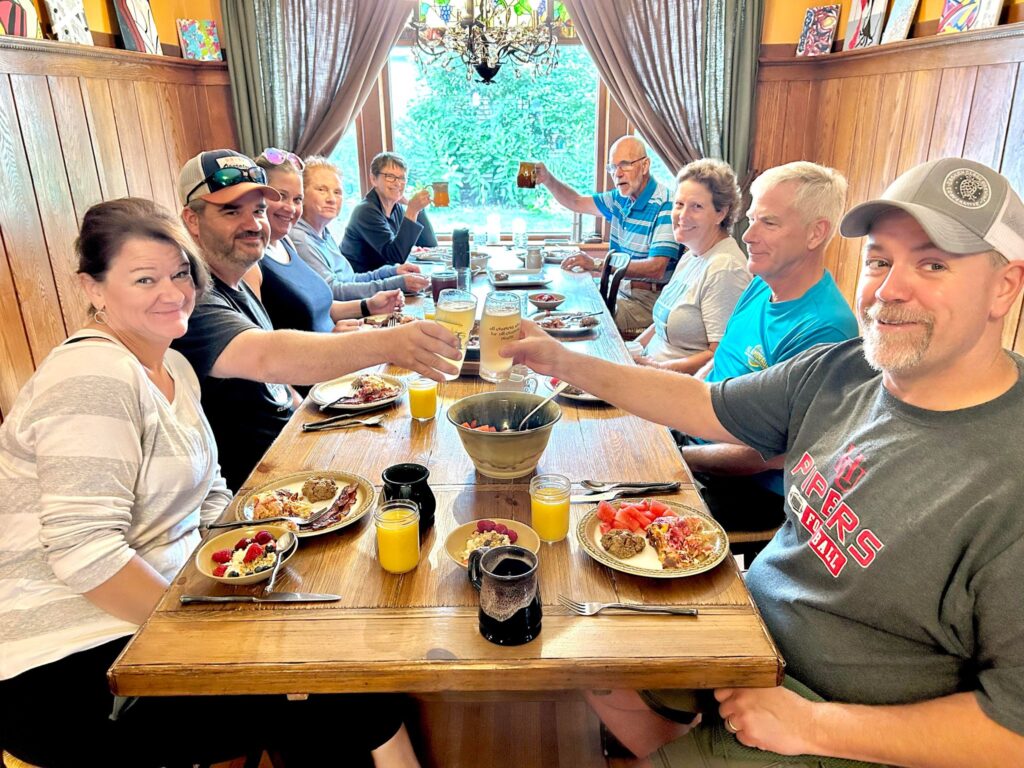 People seated around a table eating breakfast