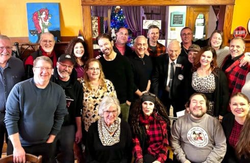 A large group of people gathered in a home for a party